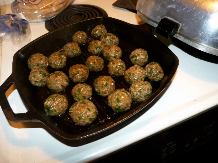 some meatballs are on the grill cooking in the oven