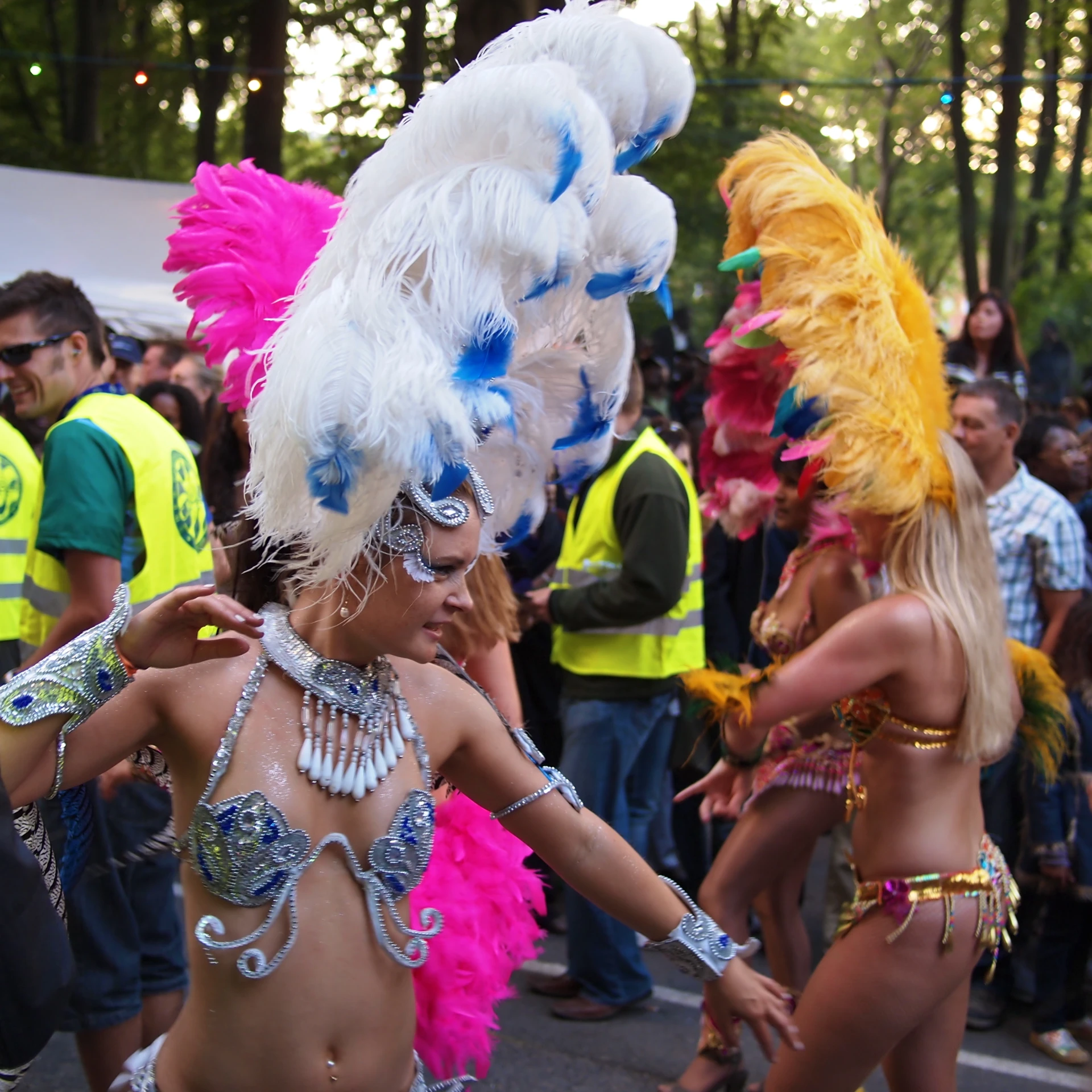 women are in colorful costumes while others dance