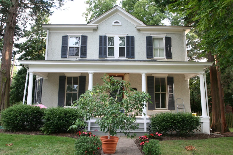 a big house that is next to some bushes