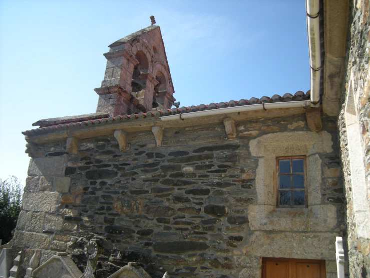 there is a tall clock tower on this old stone building