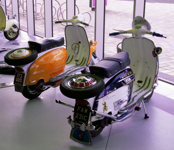 two motorcycles are displayed on display in a building