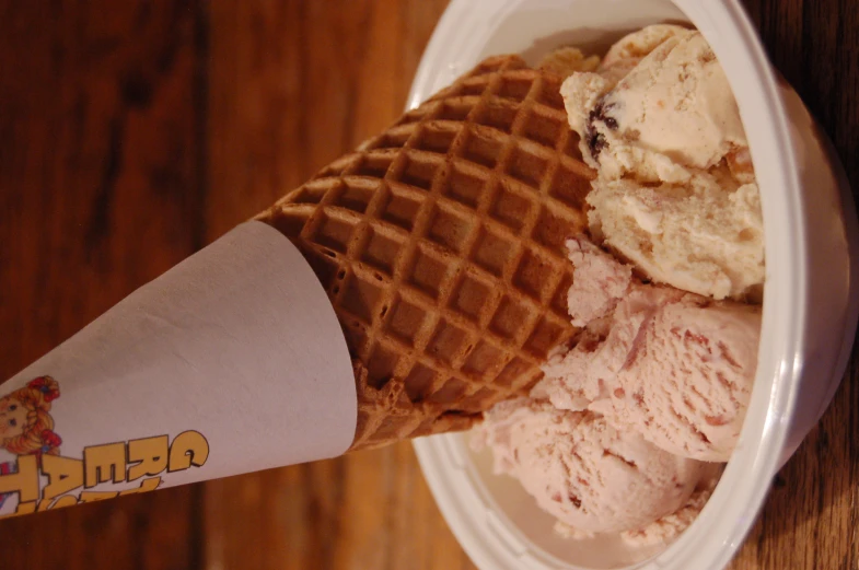 a coneed ice cream has three different flavors of ice cream