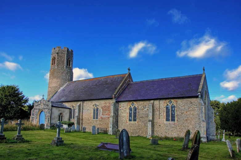 a small church sitting on top of a lush green field