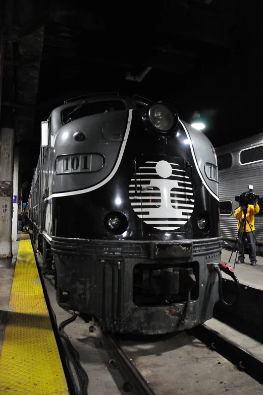 a train pulling into a station with the driver