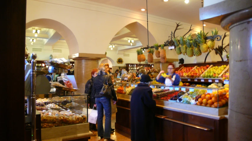 the people are enjoying a fruit and vegetable shop