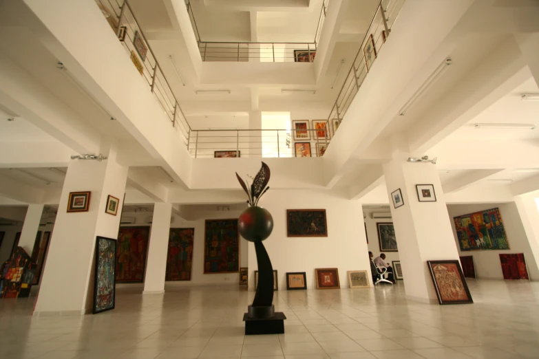 a room with art on the walls and paintings hanging in the ceiling