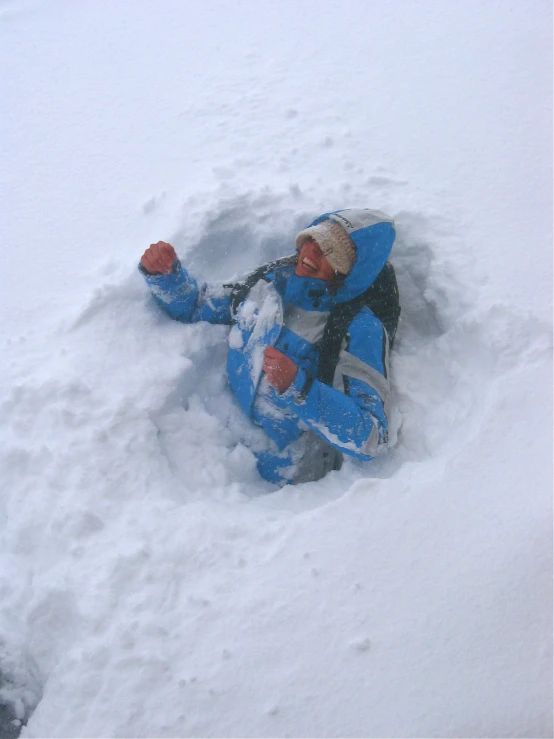 a snow boarder has fallen in the deep snow