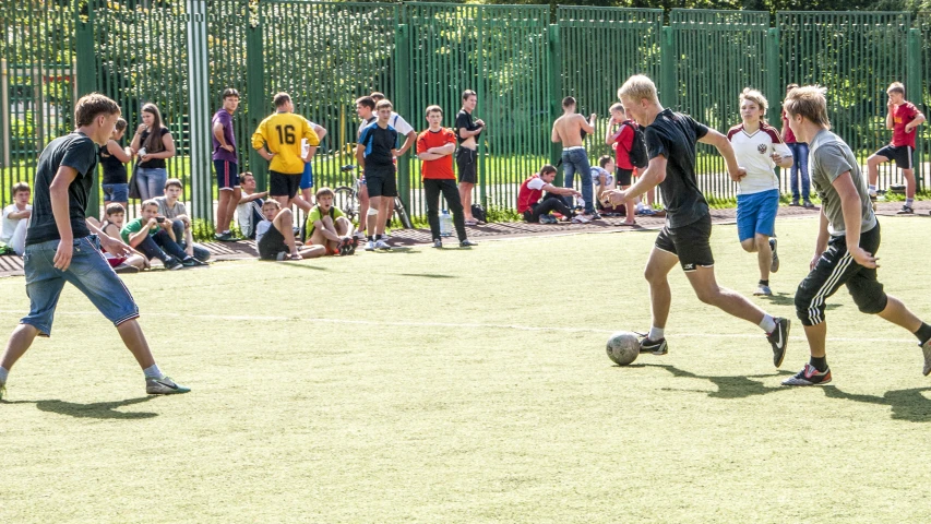 some young men are playing soccer on the field