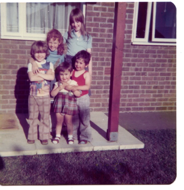 a group of children standing outside of a building