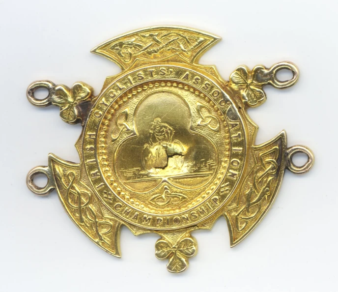 an ornate gold brooch depicting a woman