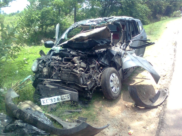 a car that has fallen over in the dirt