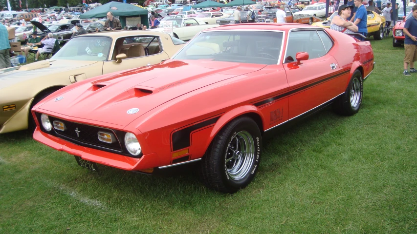 some pretty cars parked together at an outdoor car show