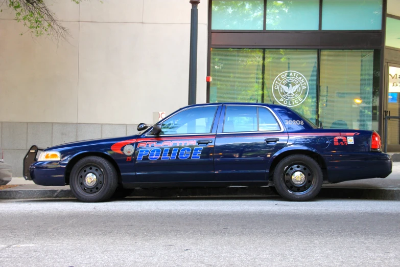 the police car is parked on the side of the street