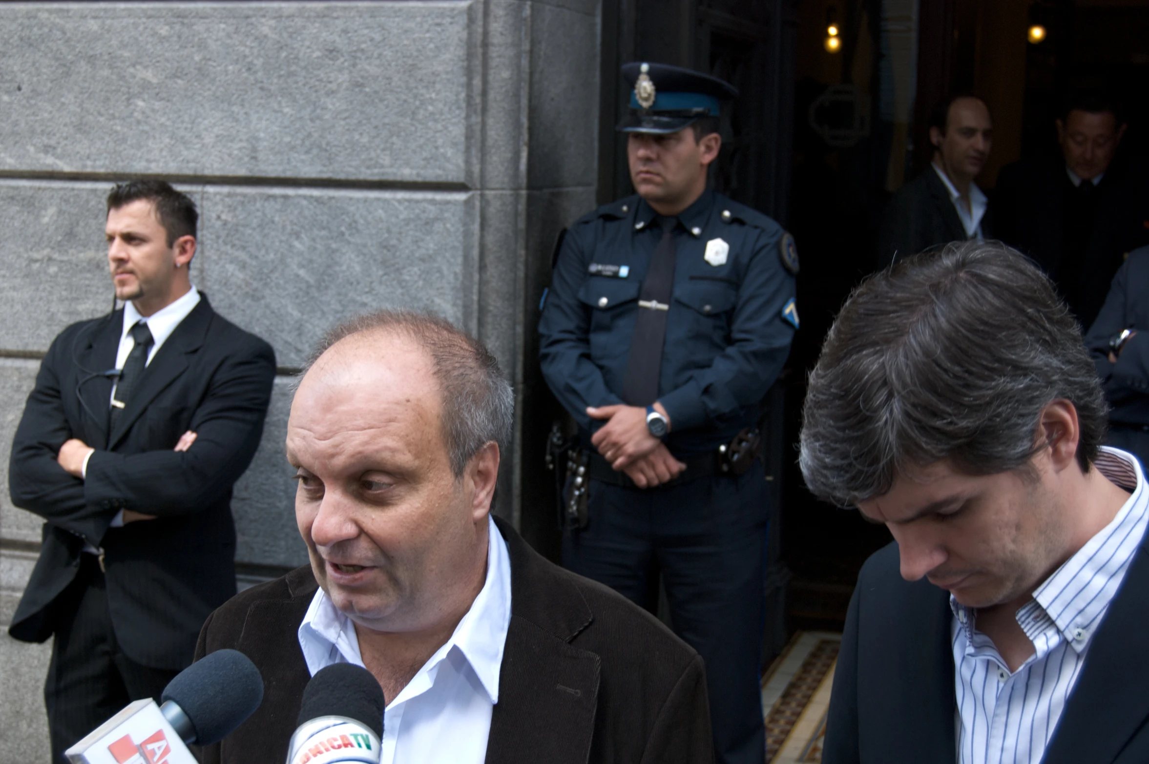 several policemen are in the doorway of a building