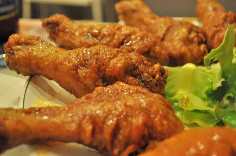 a plate of food containing broccoli and chicken wings