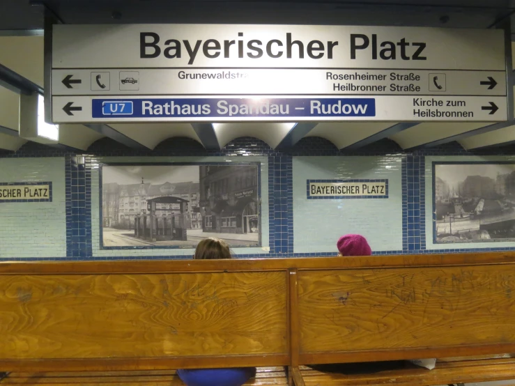 the interior of an old railway station with several signs