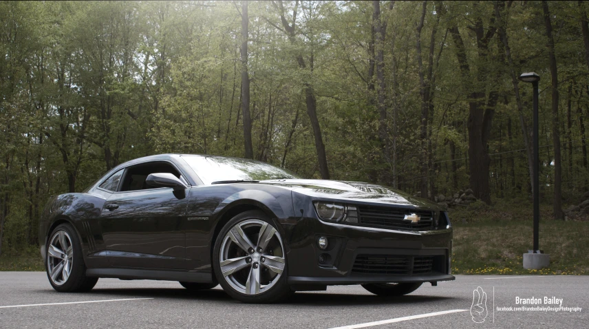 a black sports car is parked in the parking lot