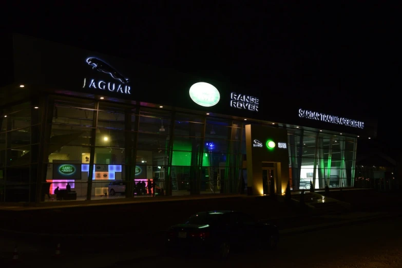 an illuminated shopping center in the dark at night