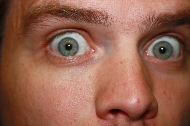 a person wearing blue eyeballs looking at the camera