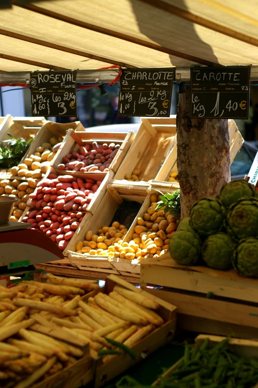 vegetables and fruits are shown on display at a market