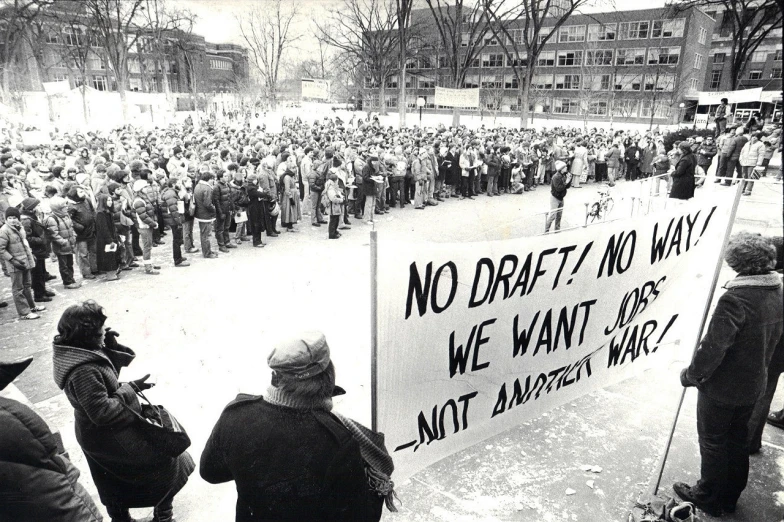 a large group of people standing around with signs