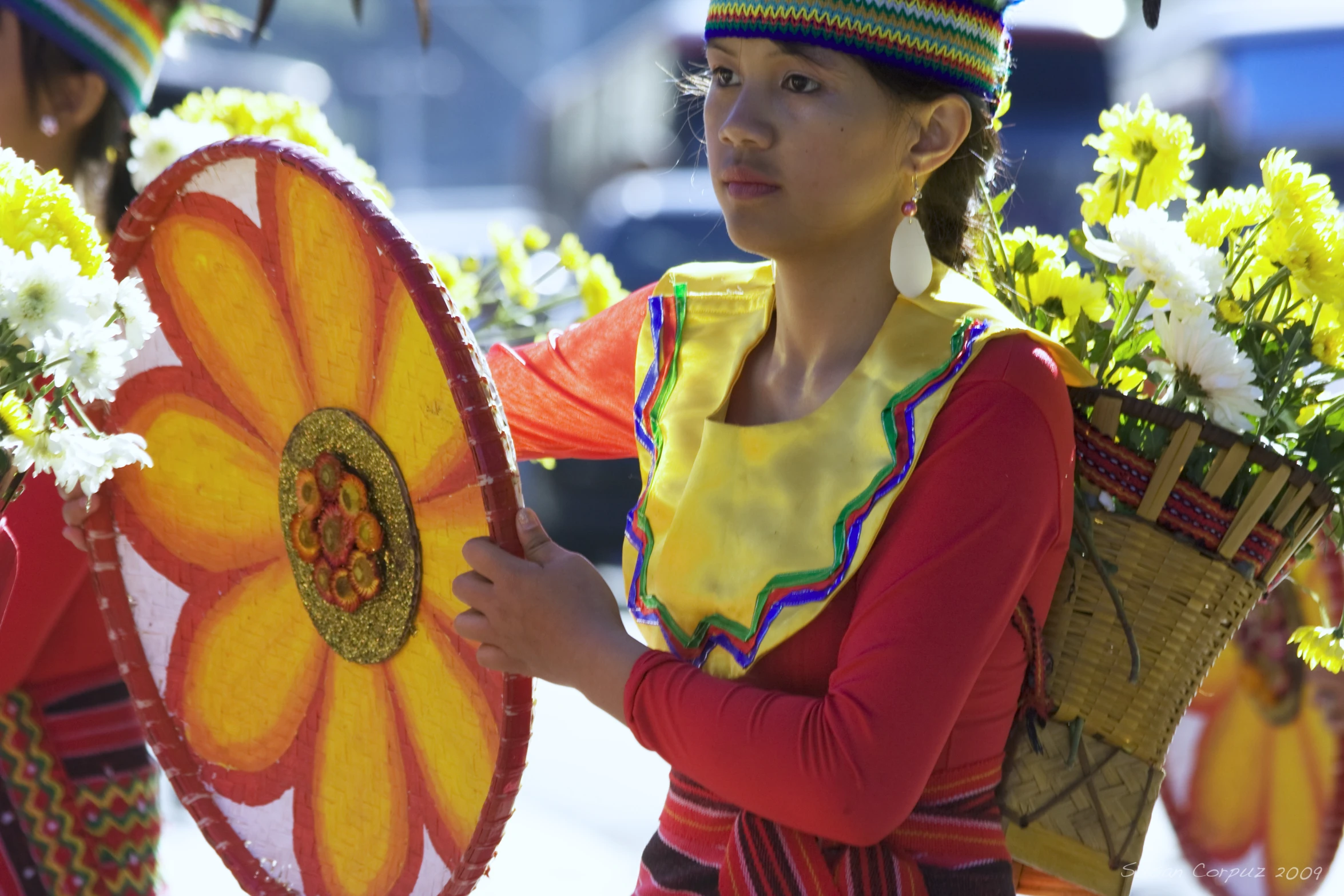 a beautiful young woman holding a large orange flower vase