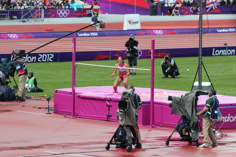the camera man is filming a woman on a track