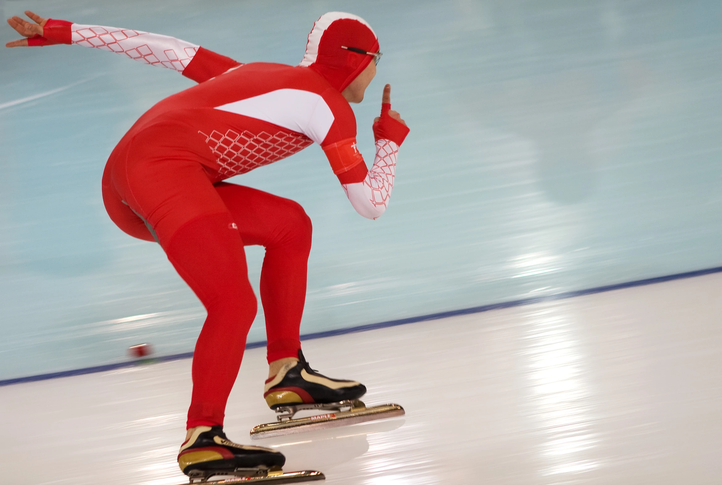 a person in a red and white outfit on skis