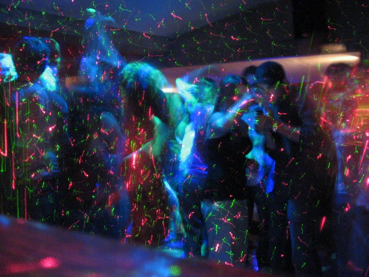 a group of people playing with laser lights