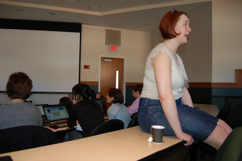 a woman sitting in front of a laptop computer