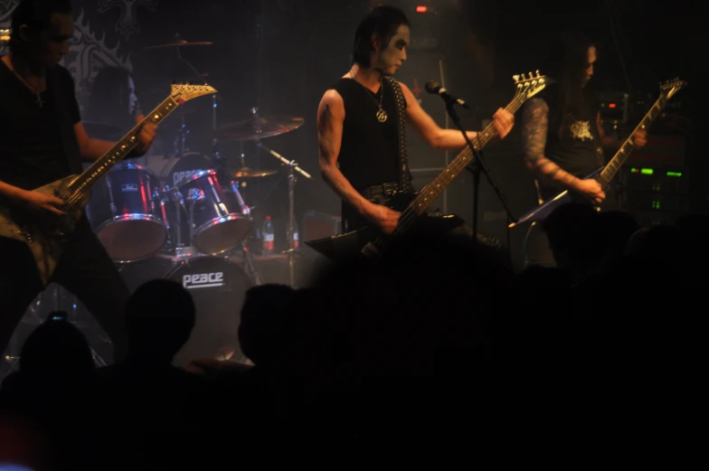 two guitarists on stage playing music together