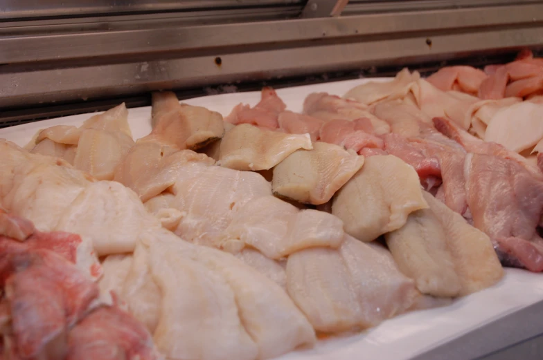 meat being served on trays and in a kitchen