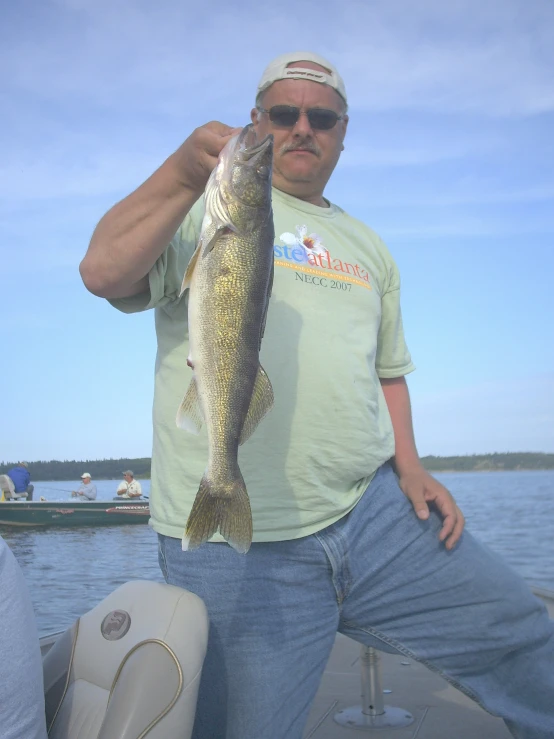 a man holding a large fish in his hand