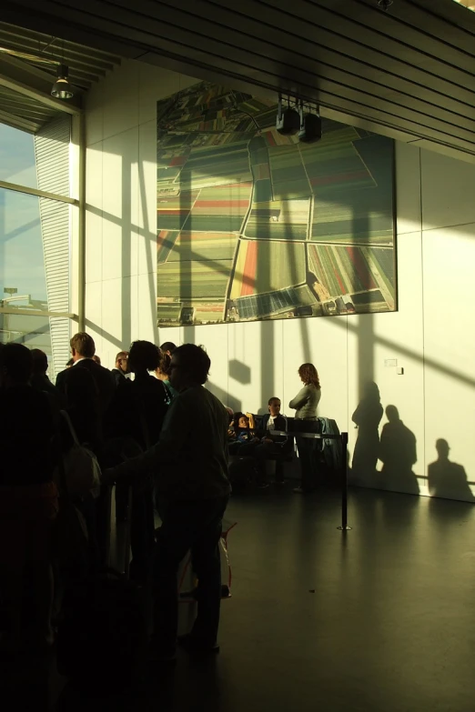 a number of people in a room with large windows