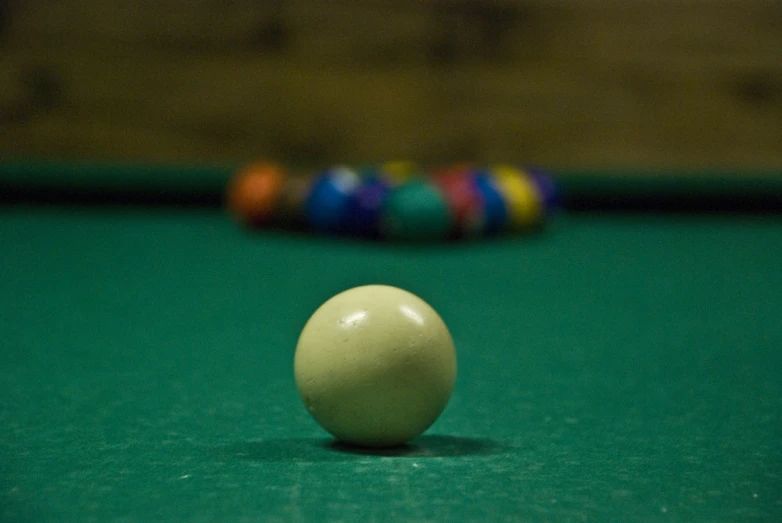 a pool ball resting on a green table