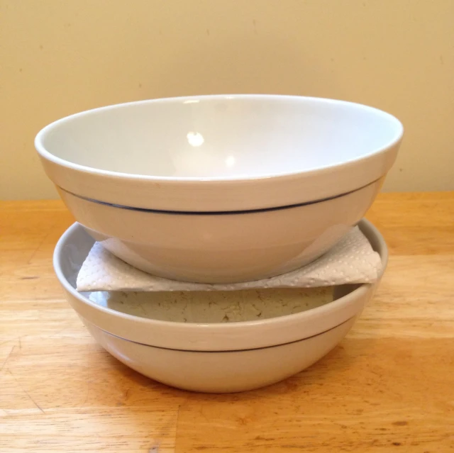 three bowls on top of each other one in the middle of a large bowl