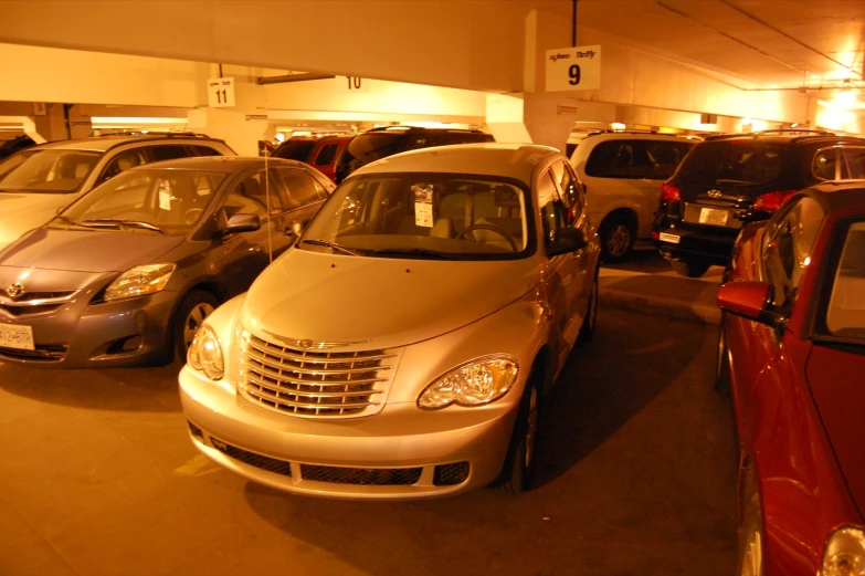 many cars parked in a parking garage at night