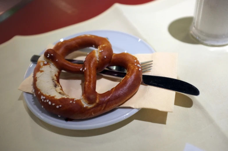 a couple of large pretzels with a fork on a plate