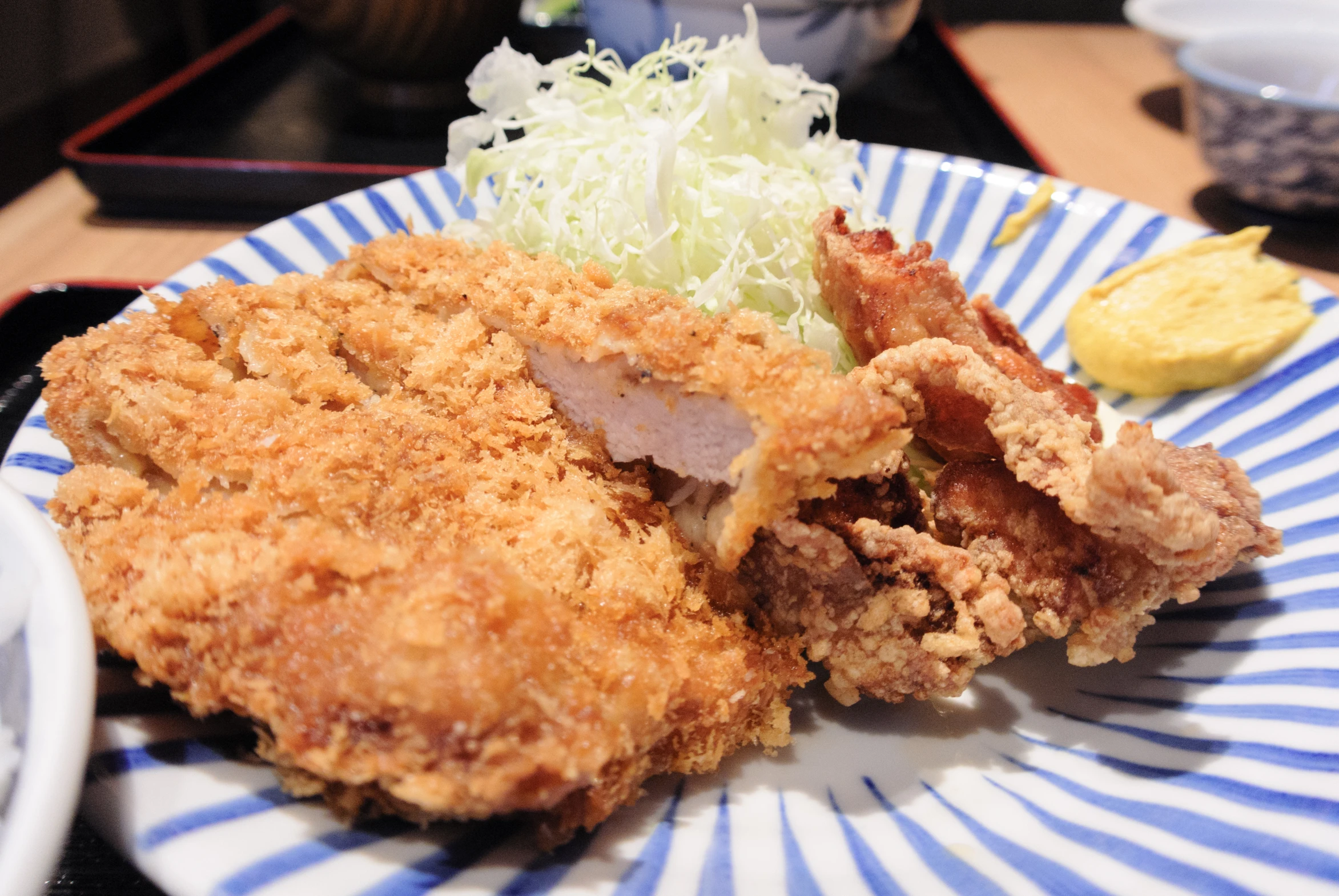 some fried food is on a blue and white plate