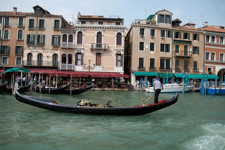 a man riding on a gondola down the street