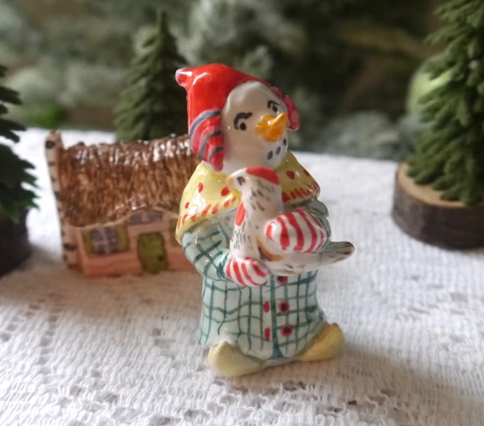 small figurine sitting in front of fake trees