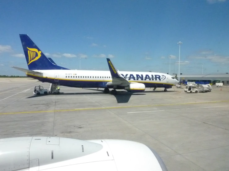 an airplane parked at the airport waiting to take off