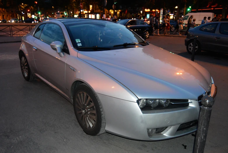 a silver car with its front bumper ripped off