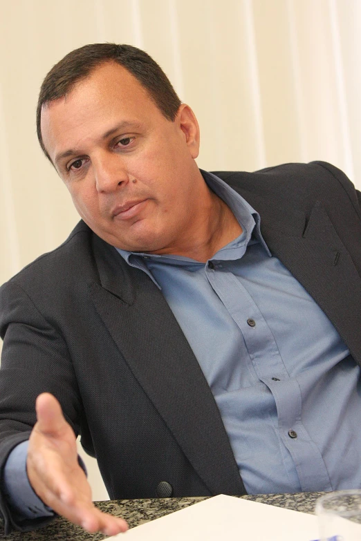 a man sitting at a table in front of a plate