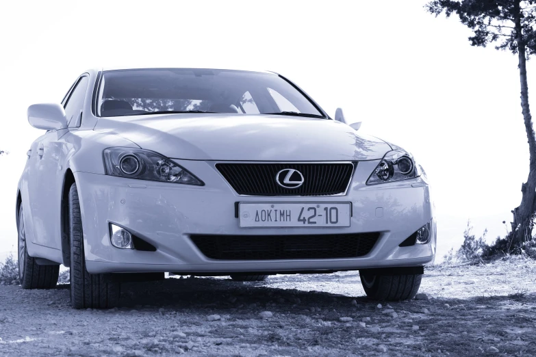 the front end of a white car parked in a field