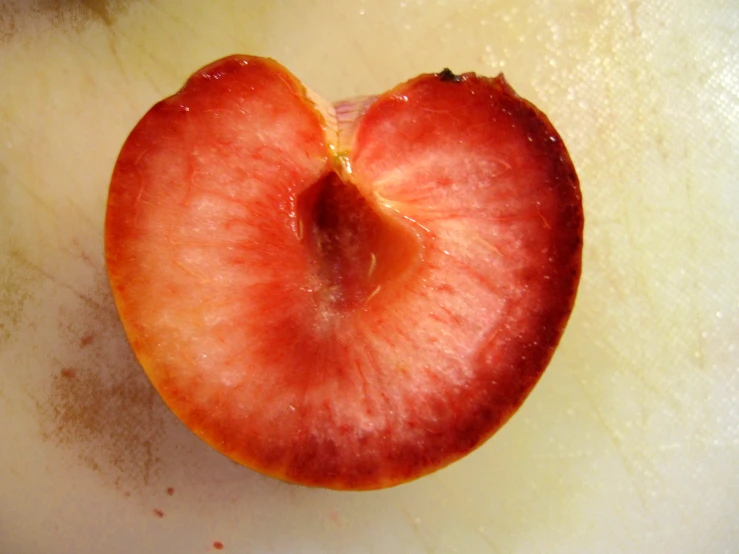 a large, ripe apple sitting in the middle of a table