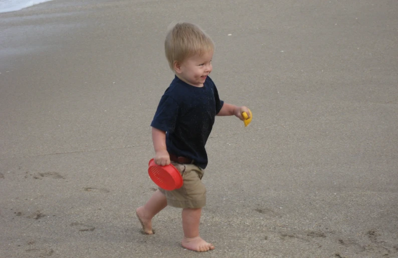 a  holding a frisbee and wearing sandals