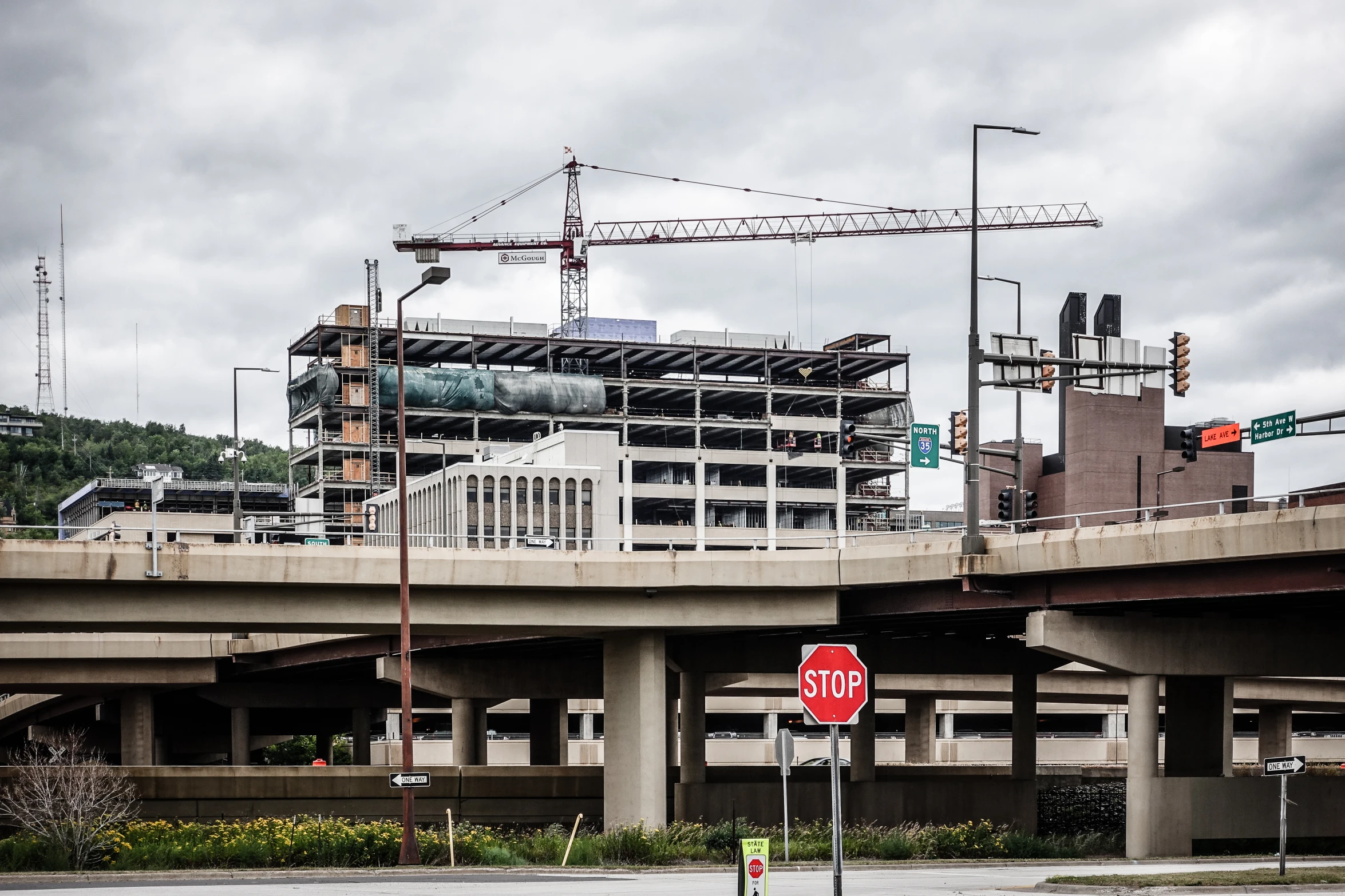 the building is under construction overpasses with street signs