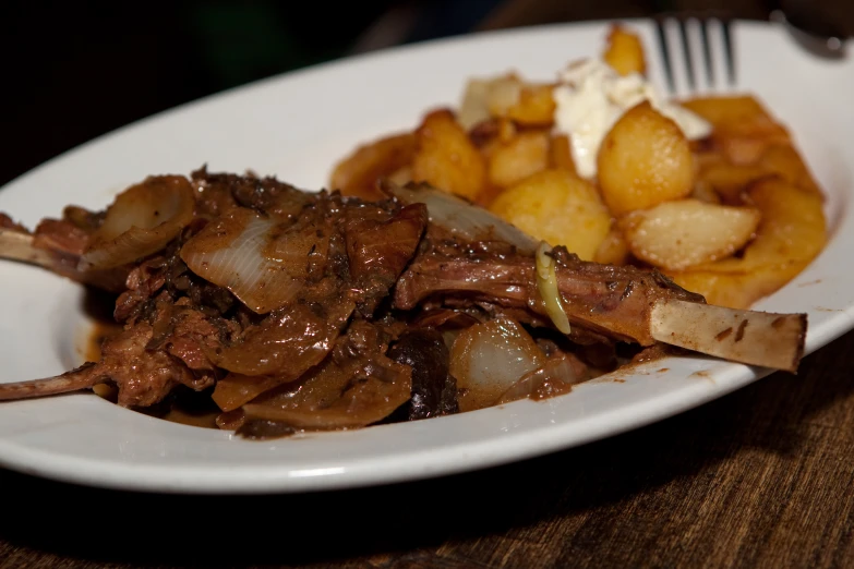 a plate of food with meat and potatoes