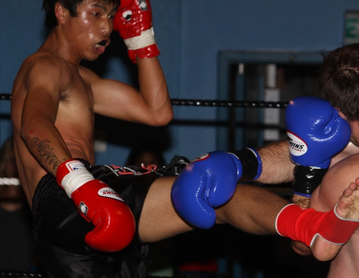 a person in red and black trunks is punching